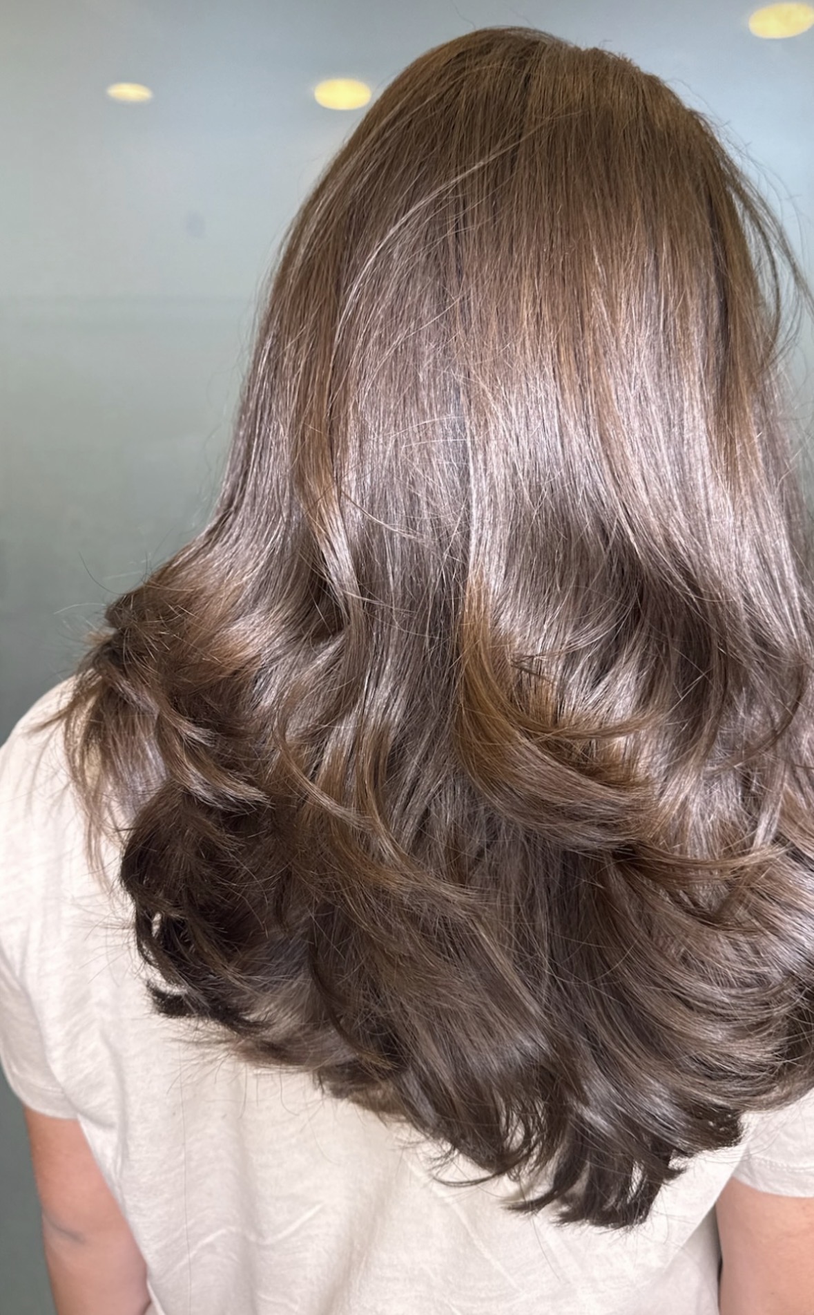 Glossy brunette hair finished in soft waves